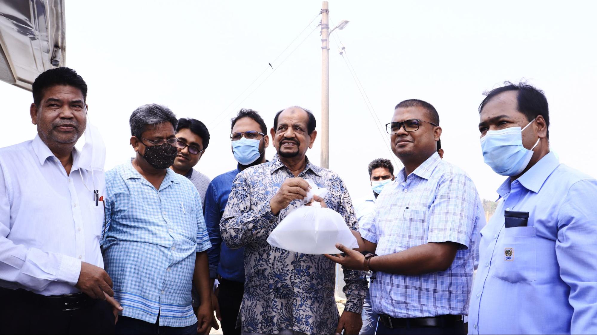 Shyamal Das holding a bag with L. vannamei post-larvae, ready to be stocked in his farm